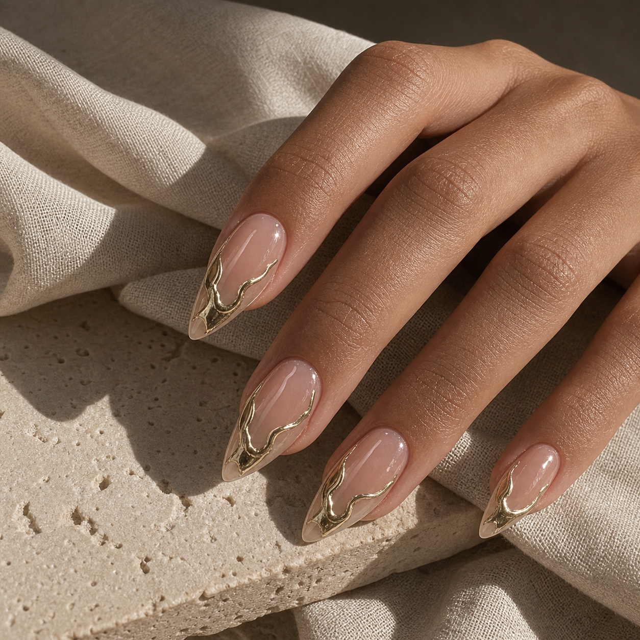 Model wearing nude molten gold press-on nails