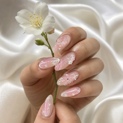 Model wearing blush pink 3D floral press-on nails