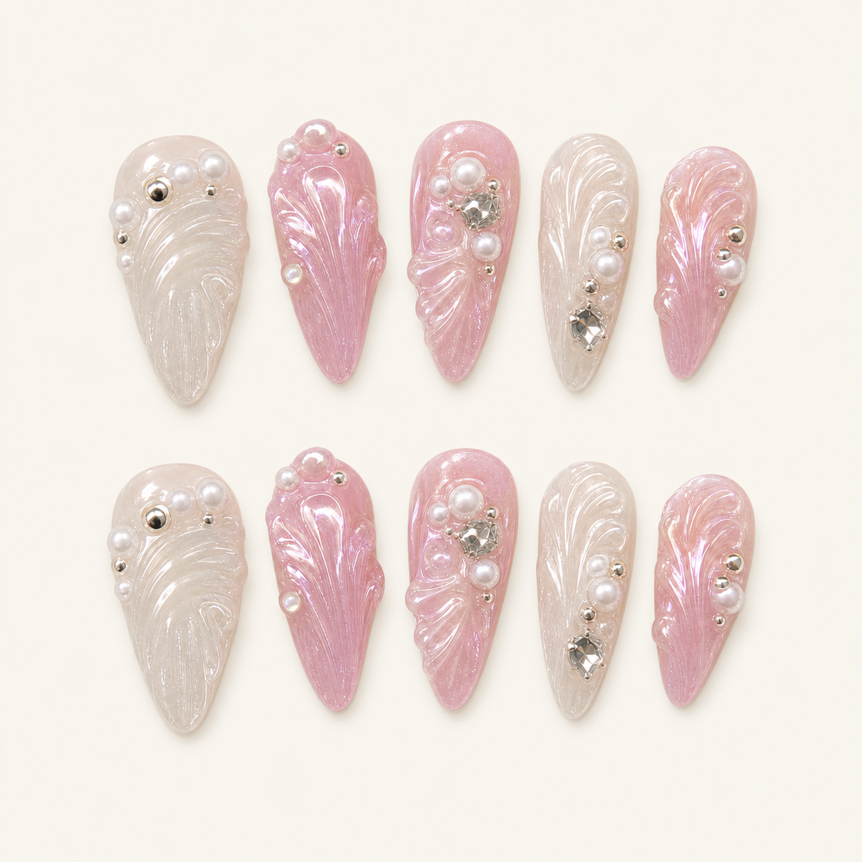 Pearl shell press-on nails on ivory background