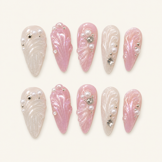 Pearl shell press-on nails on ivory background